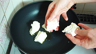 豆腐を手で大きめにちぎりながら入れる