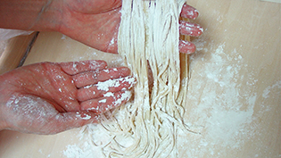 一回カッターを通すごとに麺をとりあげ、麺と麺がくっつかないように、コーンスターチか片栗粉をまぶす