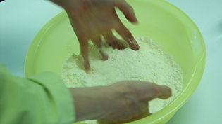指を大きく広げ、粉をすくって落とす動作を数回繰り返す